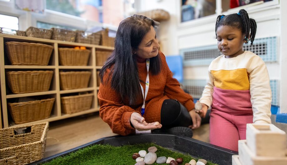 Teacher and child investigating sensory items